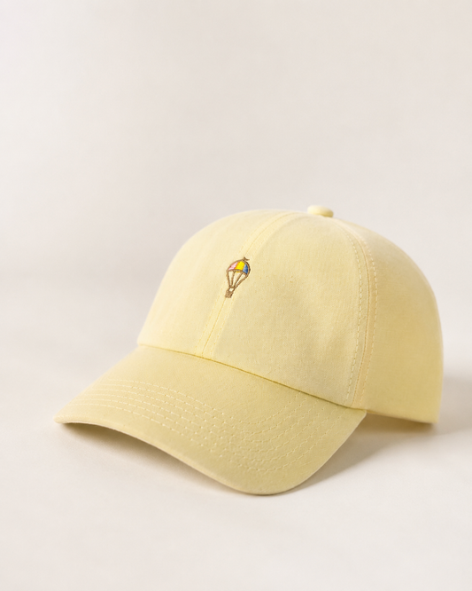 GORRA KIBLO DE LINO AMARILLO PASTEL BORDADO DE GLOBITO